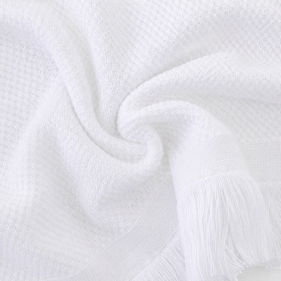 Carriage Boutique white baby blanket with textured knit pattern and elegant fringe trim for a soft heirloom look.