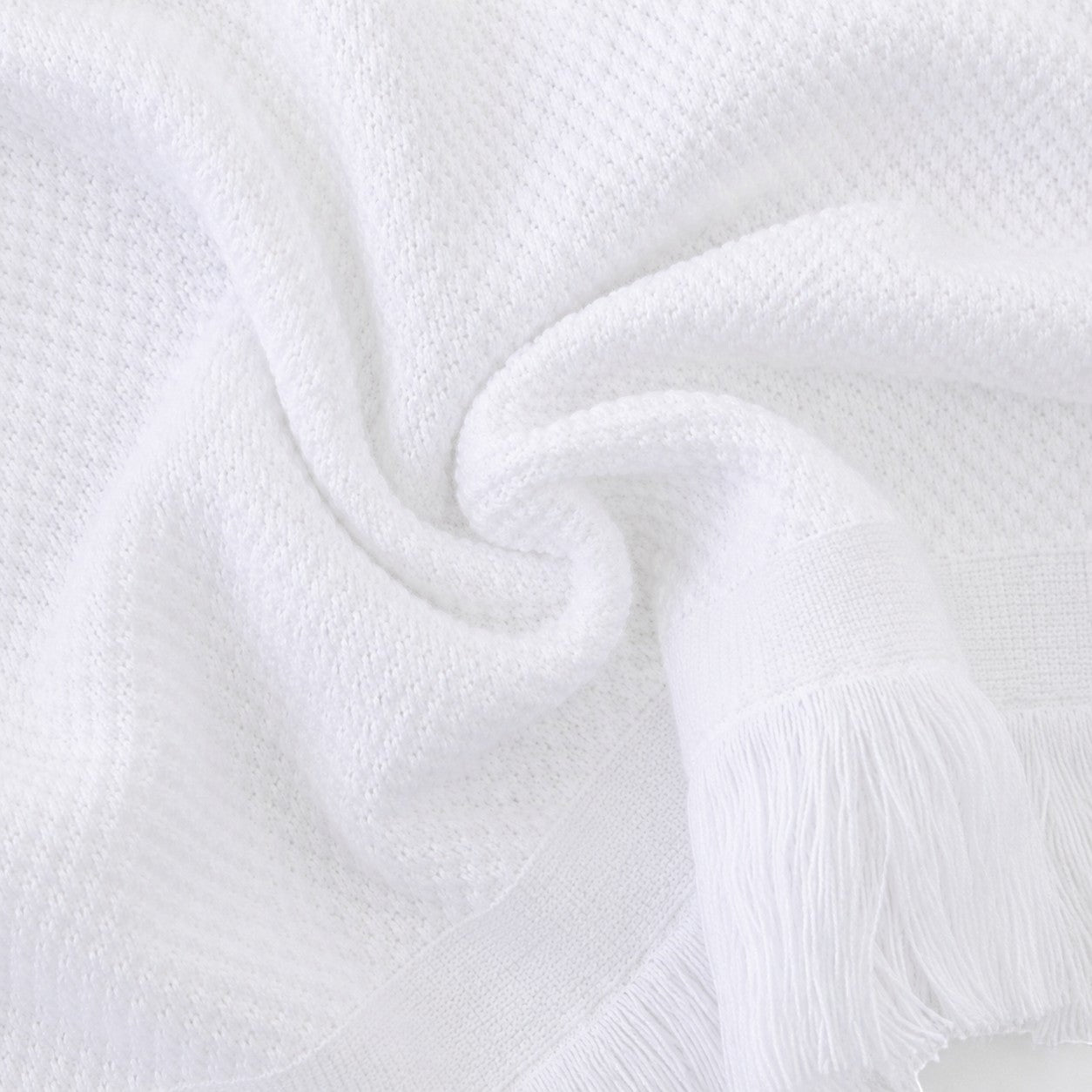 Carriage Boutique white baby blanket with textured knit pattern and elegant fringe trim for a soft heirloom look.