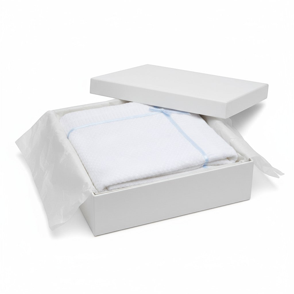 Carriage Boutique white knit baby blanket with blue satin ribbon trim and bow in a gift box