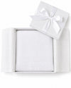 Carriage Boutique white knit baby blanket with fringe detail, presented in a gift box with a satin ribbon.