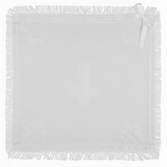 Carriage Boutique white knit baby blanket with fringe trim and a delicate satin ribbon bow corner accent