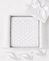 Carriage Boutique white cotton knit baby blanket with shell texture in a gift box with a satin ribbon.