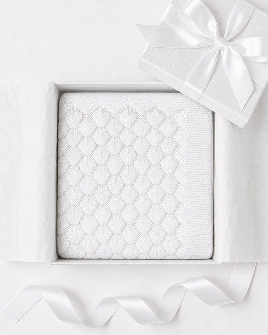 Carriage Boutique white cotton knit baby blanket with shell texture in a gift box with a satin ribbon.