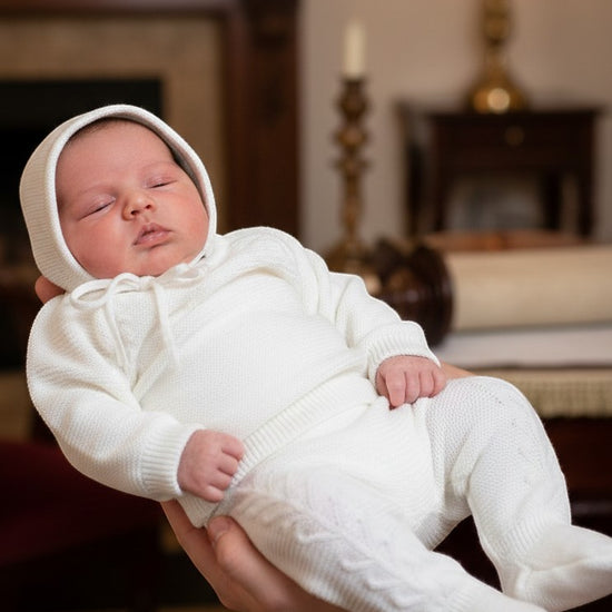 Carriage Boutique white knit baby boy christening romper and matching bonnet with delicate leaf pattern detail