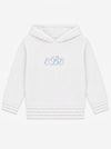 Carriage Boutique soft white knit baby hoodie with blue monogram embroidery on the chest and a zip-back closure.