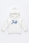 Carriage Boutique white knit baby hoodie with hood and blue embroidered name on the front