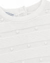 Carriage Boutique white knit baby bris outfit featuring textured pom-pom details and a button-back closure.