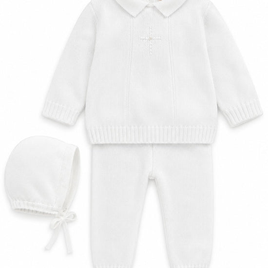 Carriage Boutique white knit baptism outfit for baby boys featuring a pearl cross, collared top, pants, and bonnet.
