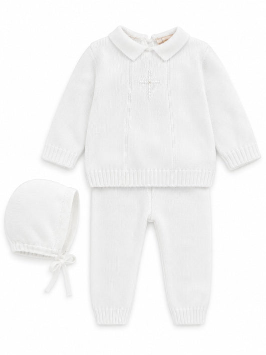 Carriage Boutique white knit baptism outfit for baby boys featuring a pearl cross, collared top, pants, and bonnet.