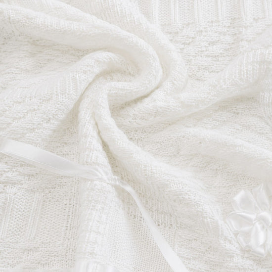 Carriage Boutique white knit christening blanket with satin ribbon bows and delicate textured pattern