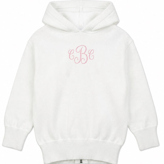 Carriage Boutique white cotton knit baby sweater with a hood, zip back, and pink monogram embroidery on the chest.