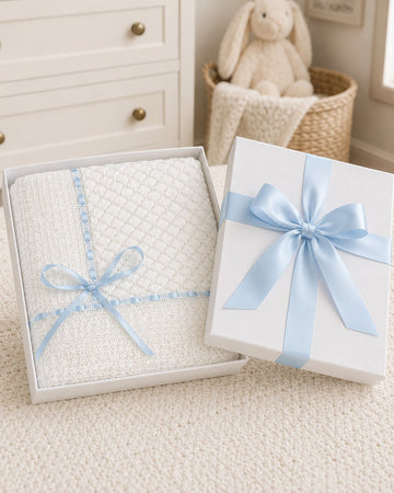 Carriage Boutique white baby blanket with Belgium lace and blue ribbon in a gift box