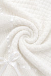 Carriage Boutique white baby blanket featuring soft knit texture, delicate Belgium lace, and a satin ribbon bow.