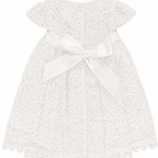Carriage Boutique white lace baptism dress with short sleeves and a satin bow back detail for christening ceremonies.