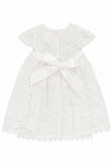 Carriage Boutique white lace baptism dress with short sleeves and a satin bow back detail for christening ceremonies.