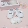 Carriage Boutique white lace ballet flats with satin bows and a matching chiffon flower headband with pearls for baby girls.