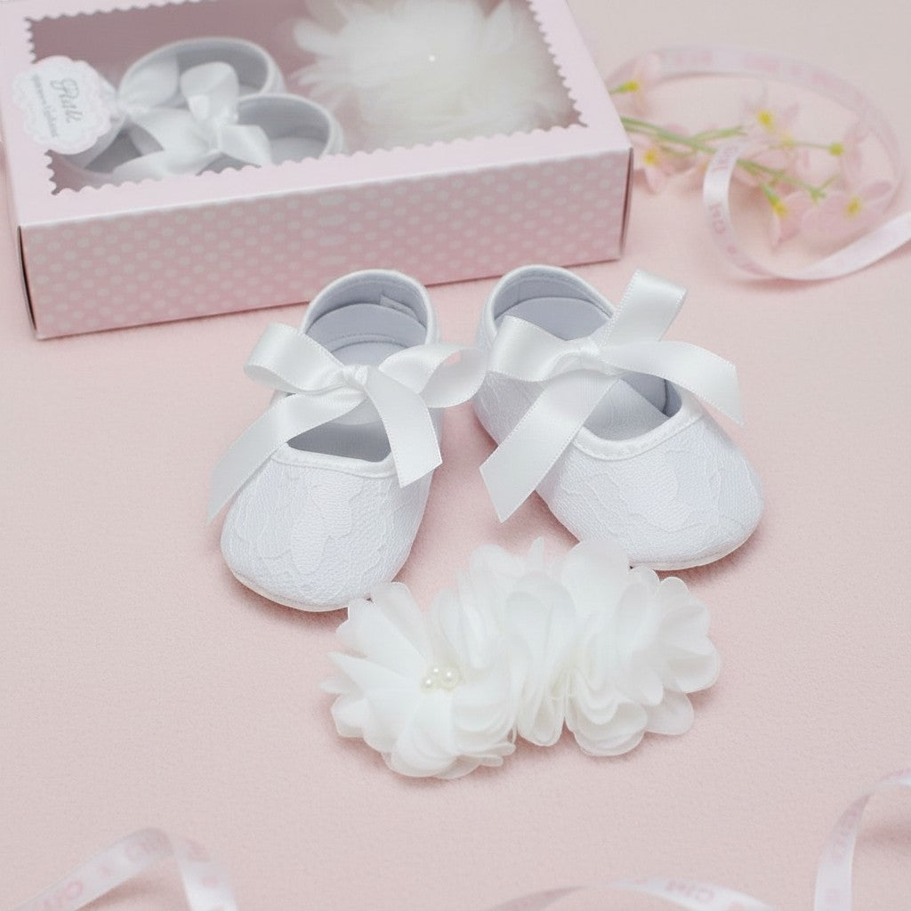 Carriage Boutique white lace ballet flats with satin bows and a matching chiffon flower headband with pearls for baby girls.
