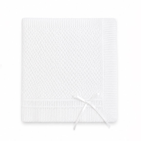Carriage Boutique white christening blanket featuring delicate Belgium lace texture and a decorative ribbon bow.