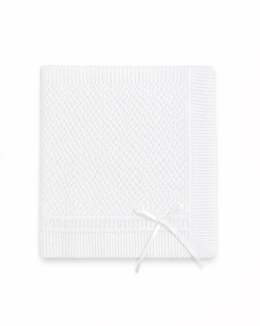 Carriage Boutique white christening blanket featuring delicate Belgium lace texture and a decorative ribbon bow.