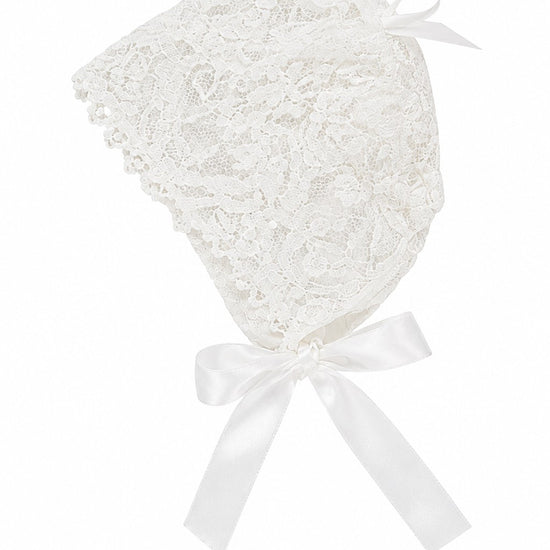 Carriage Boutique white lace christening bonnet with delicate floral patterns and a satin ribbon tie closure.