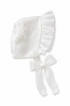 Carriage Boutique white satin christening bonnet with delicate lace embroidery, scalloped trim, and organza ribbon tie.
