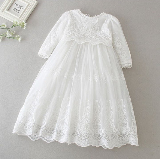 Carriage Boutique white long sleeve christening gown featuring intricate lace embroidery and a scalloped hem