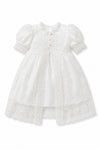 Carriage Boutique white lace christening gown with puffed sleeves, satin base, and intricate embroidery details.