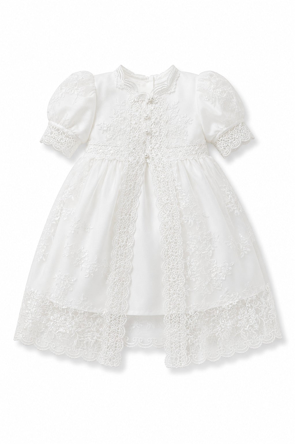 Carriage Boutique white lace christening gown with puffed sleeves, satin base, and intricate embroidery details.