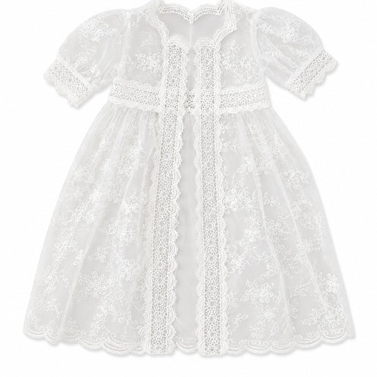 Carriage Boutique white lace christening gown with delicate embroidery, scalloped edges, and short puffed sleeves.