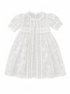 Carriage Boutique white lace christening gown with delicate embroidery, scalloped edges, and short puffed sleeves.