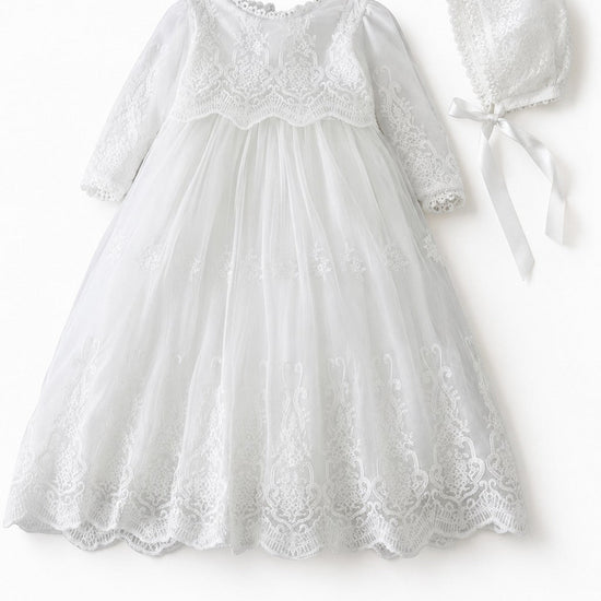 Carriage Boutique white long sleeve christening gown with intricate lace embroidery and matching scalloped bonnet