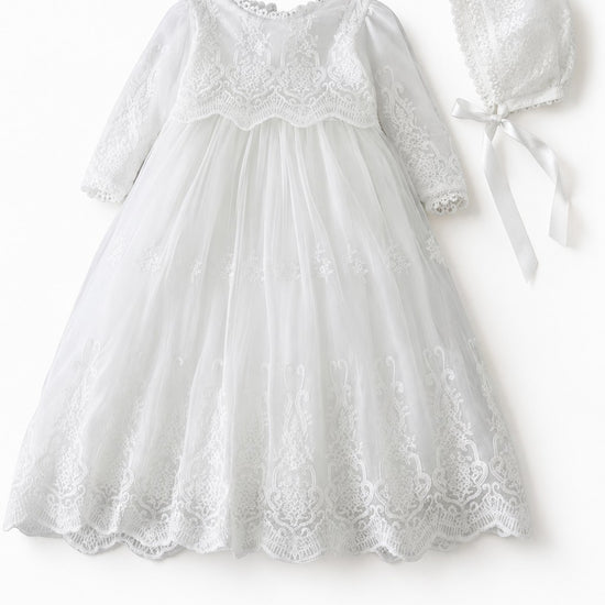 Carriage Boutique white long sleeve lace christening gown with intricate embroidery, scalloped hem, and matching bonnet.