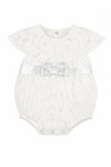 Carriage Boutique white lace baby girl christening bubble romper with a satin waist ribbon and bow detail.