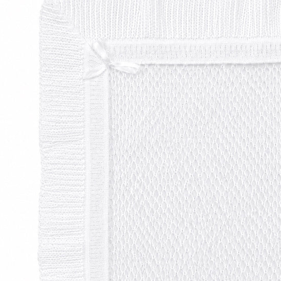 Carriage Boutique white christening blanket with delicate Belgium lace, ribbed border, and a small satin ribbon bow.