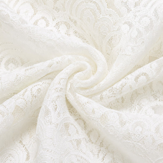 Carriage Boutique white christening gown fabric featuring intricate floral lace patterns and delicate texture