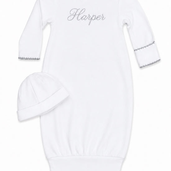 Carriage Boutique white newborn sleep sack with matching hat featuring elegant scalloped trim and custom embroidery