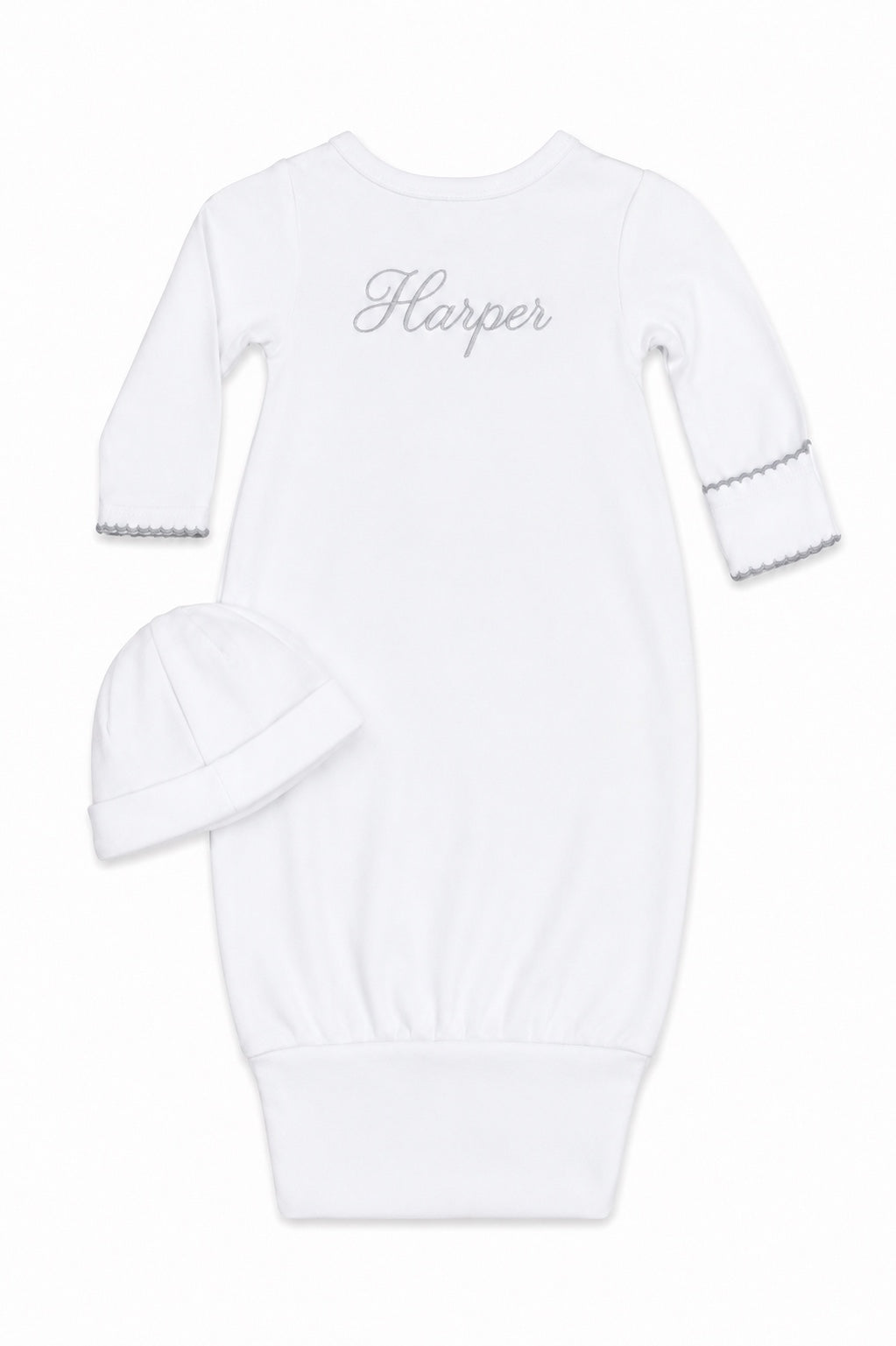 Carriage Boutique white newborn sleep sack with matching hat featuring elegant scalloped trim and custom embroidery