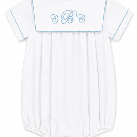 Carriage Boutique white cotton baby boy romper with blue trim and custom embroidered monogram on the sailor collar.