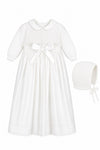 Carriage Boutique white baby girl christening gown with pebble stitch bodice, satin bow, and matching bonnet.