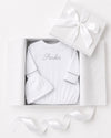 Carriage Boutique white newborn sleep sack and matching hat with personalized embroidery in a gift box.