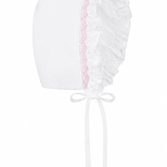 Carriage Boutique white baby bonnet with delicate pink embroidery and ruffled trim for a christening gown
