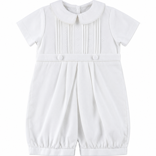 Carriage Boutique white pique baby boy romper with a Peter Pan collar, pleated bodice, and button detailing.