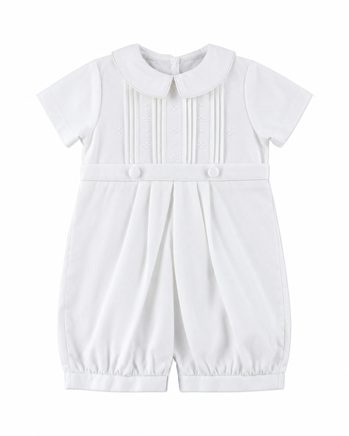 Carriage Boutique white pique baby boy romper with a Peter Pan collar, pleated bodice, and button detailing.