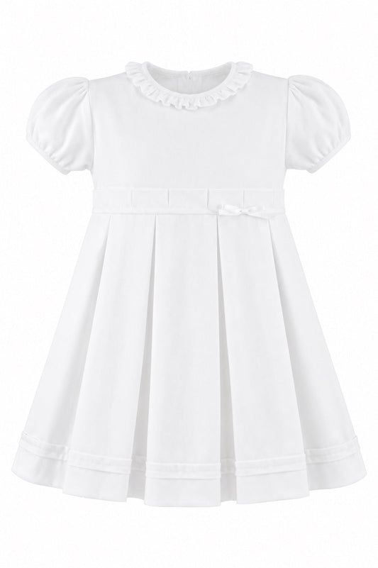 Carriage Boutique white pique baby and toddler girl dress with a ruffled collar, puff sleeves, and a bow waist detail.