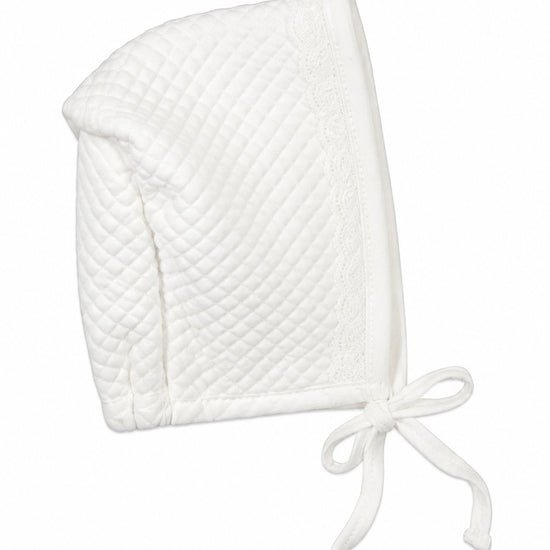 Carriage Boutique white quilted baby bonnet with delicate lace trim and ribbon tie for a bris ceremony.
