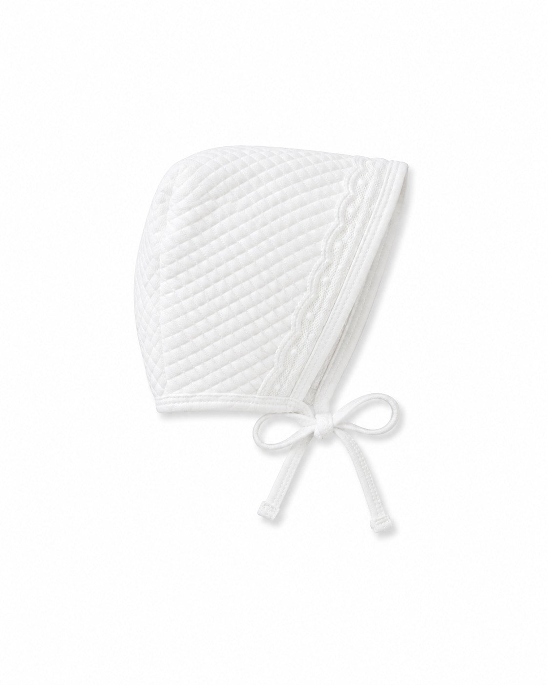 Carriage Boutique white quilted baby bonnet with delicate lace trim and tie closure for a traditional bris outfit.