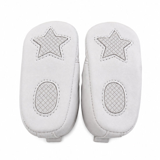Carriage Boutique white quilted baby boy christening shoes with star and oval grip patterns on the soles