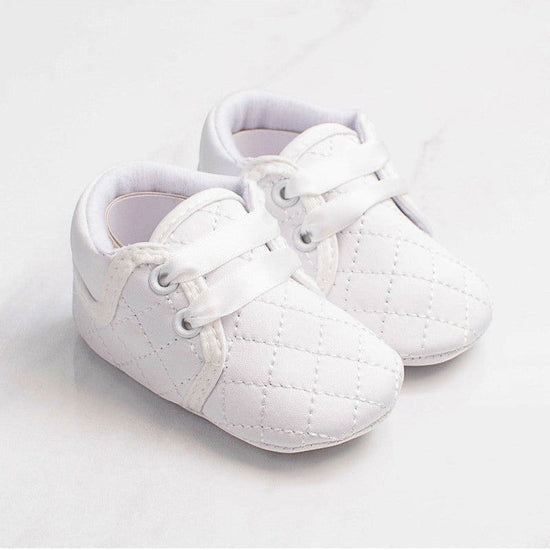 Carriage Boutique white quilted baby boy christening shoes with soft soles and satin ribbon laces for baptism.