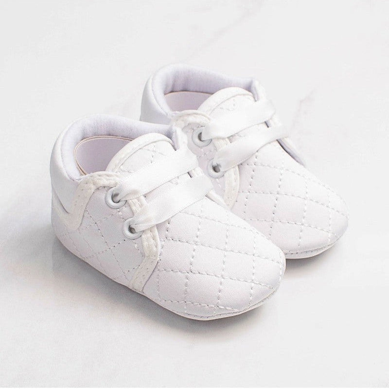 Carriage Boutique white quilted baby boy christening shoes with soft soles and satin ribbon laces for baptism.