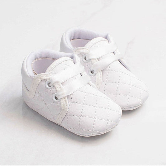 Carriage Boutique white quilted baby boy christening shoes with soft soles and satin ribbon laces for baptism.